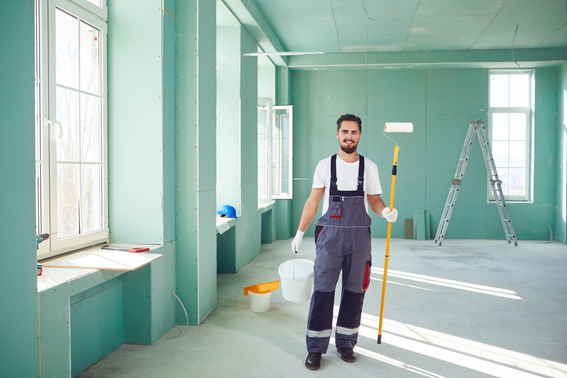 Bearded painter construction worker on a construction site.