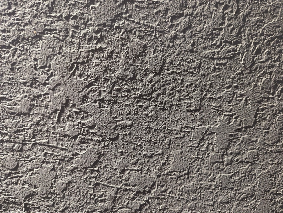 a close up of a cement wall with cracks